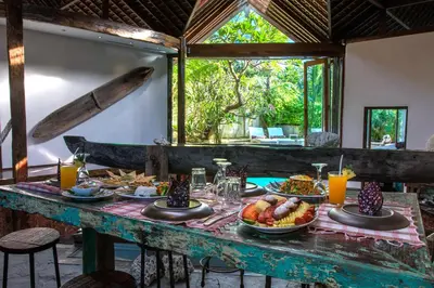 a table with food on it in a room at Phinisi Villas - Seminyak Beach in Seminyak