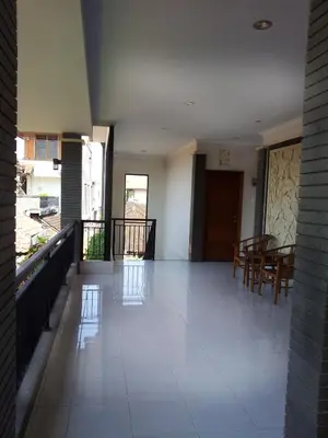 a room with a hallway with a table and chairs at Pondok Mirah in Kuta