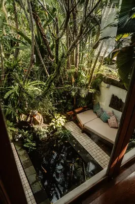 a room with a couch in the jungle at Villa Istimewa in Seminyak