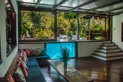 a large aquarium in a living room with a couch at Villa Istimewa in Seminyak