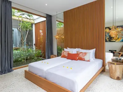 a bedroom with a large bed with white sheets at Villa Castil di Udara by Villa Finder in Kerobokan
