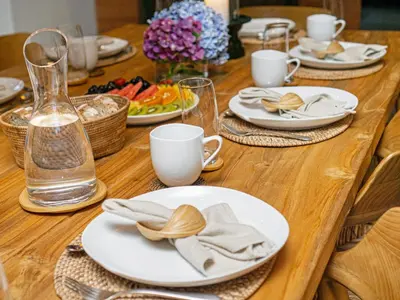 a wooden table with plates of food on it at Villa Castil di Udara by Villa Finder in Kerobokan