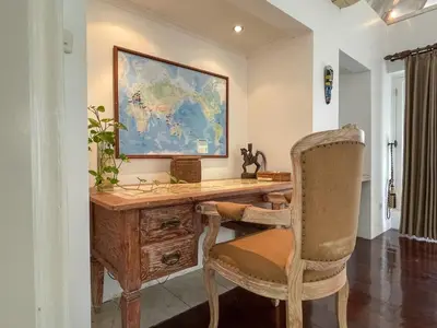 a home office with a desk and a chair at Beach House Canggu - 150m Berawa beach in Canggu