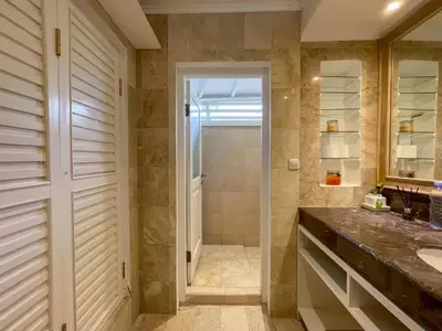 a bathroom with a shower and a sink at Beach House Canggu - 150m Berawa beach in Canggu