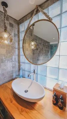 a bathroom with a white sink and a mirror at Amnaya Resort Nusa Dua in Nusa Dua