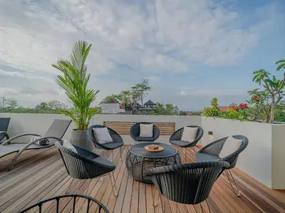 a patio with chairs and a table on a deck at Villa Mimpi Bali in Jimbaran