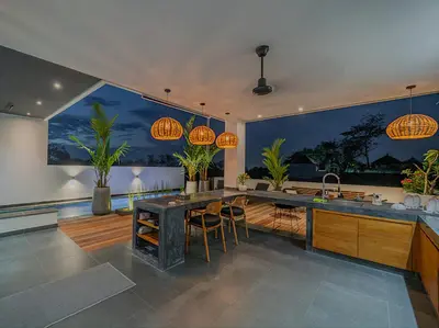 an open kitchen with a large island in a house at Villa Mimpi Bali in Jimbaran