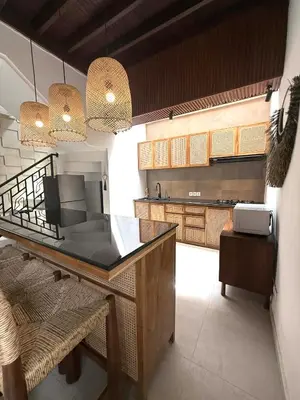 a kitchen with a counter top in a room at de CINTA Villa - KUTA - 6 bedrooms - Heart of Kuta in Kuta