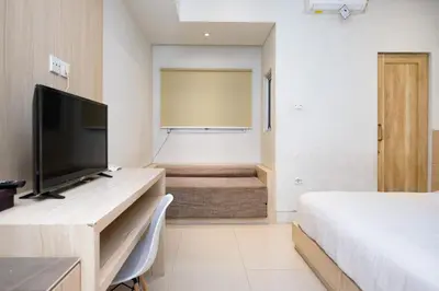 a bedroom with a bed and a projection screen at Lega Legi Town House Seminyak by The Lavana in Seminyak