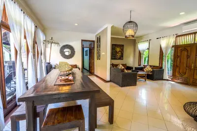 a living room with a table and a couch at Villa SANKET - KUTA - 6 bedrooms - 6 bathrooms - Great Location in Kuta
