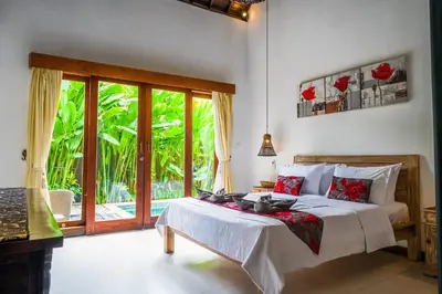 a bedroom with a bed and a sliding glass door at Villa CRIS - Heart of LEGIAN 3 Bedrooms, 3 Bathrooms in Legian