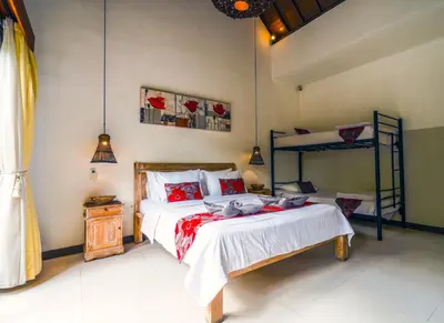 a bedroom with a bed and a bunk bed at Villa CRIS - Heart of LEGIAN 3 Bedrooms, 3 Bathrooms in Legian