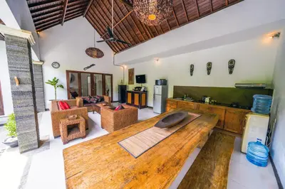 a large living room with a large wooden table at Villa CRIS - Heart of LEGIAN 3 Bedrooms, 3 Bathrooms in Legian