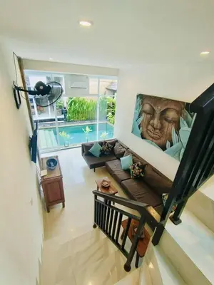 a living room with a couch and a swimming pool at OASIS 66 Villa - Heart of Legian/Seminyak - Double Six in Seminyak