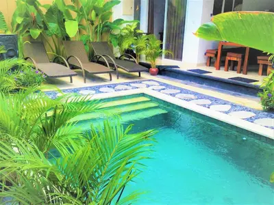a small swimming pool with chairs in a yard at OASIS 66 Villa - Heart of Legian/Seminyak - Double Six in Seminyak