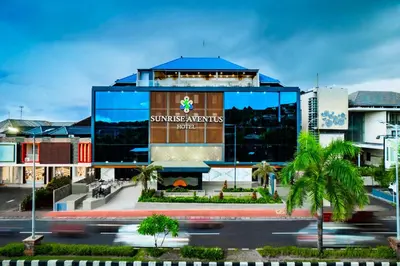 a building with a sign on the side of it at Sunrise Aventus Hotel Nusa Dua in Nusa Dua