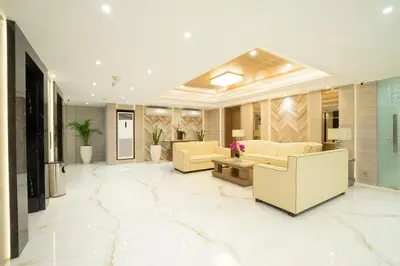 a lobby with two yellow couches and a table at Sunrise Aventus Hotel Nusa Dua in Nusa Dua