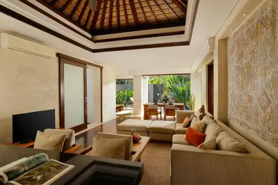 a living room with a couch and a table at Jimbaran Bay Villas by Nakula in Jimbaran