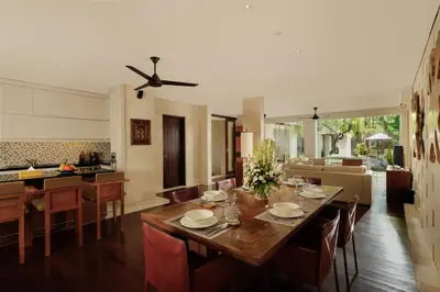 a dining room and kitchen with a table and chairs at Jimbaran Bay Villas by Nakula in Jimbaran