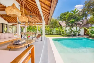 an outdoor patio with a swimming pool and a villa at Villa Baladeva - 5 BDR Luxury Villa with huge private Pool in Kuta