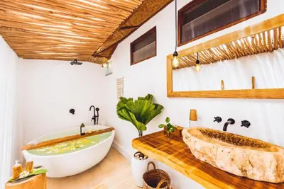 a bathroom with a large tub and a sink at Villa Baladeva - 5 BDR Luxury Villa with huge private Pool in Kuta