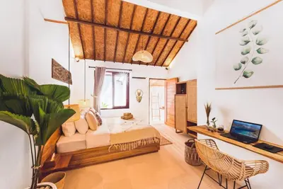 a bedroom with a bed and a table and chairs at Villa Baladeva - 5 BDR Luxury Villa with huge private Pool in Kuta