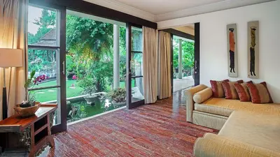 a living room with a couch and large windows at Villa Avalon by Elite Havens in Canggu
