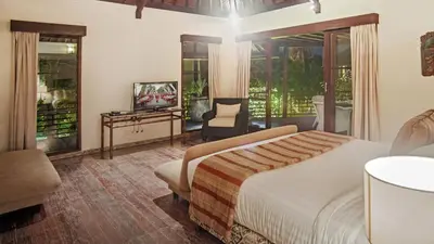 a bedroom with a bed and a television in it at Villa Avalon by Elite Havens in Canggu