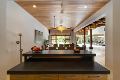 an open living room with a large island in the middle at Villa Kinaree Estate in Seminyak