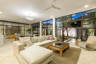 a living room with a couch and a table at Villa Lumut 3 Bedrooms Central Seminyak in Seminyak