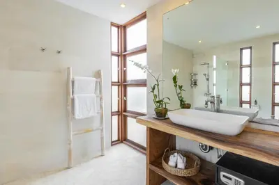 a bathroom with a sink and a mirror at Villa Lumut 3 Bedrooms Central Seminyak in Seminyak