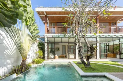 an exterior view of a house with a swimming pool at Villa Lumut 3 Bedrooms Central Seminyak in Seminyak
