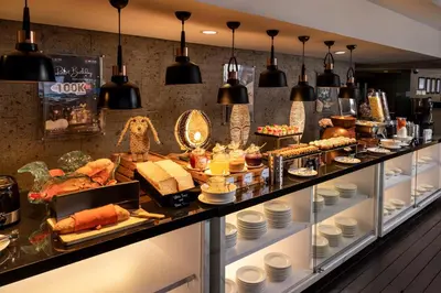 a buffet line with a lot of food on display at J4 Hotels Legian in Legian