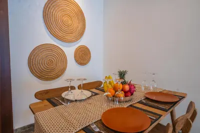 a dining room table with fruits and plates on it at Canggu Escape Villa By Island Escape in Canggu