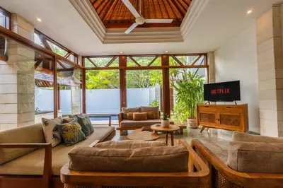 a living room with two couches and a tv at Canggu Escape Villa By Island Escape in Canggu