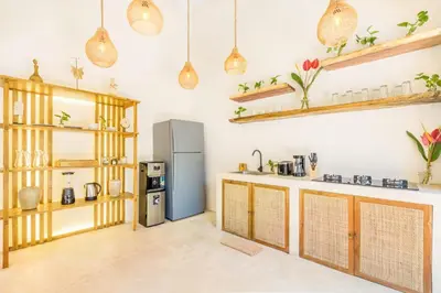 a kitchen with wooden cabinets and a refrigerator at Villa Tokyo - 3 BDR Private Villa - 3 min walk to KU DE TA beach in Kuta