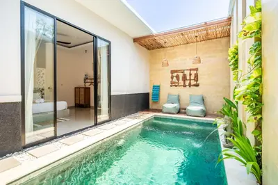 a swimming pool in the middle of a house at Kamaratih Villas by Maheswara in Legian