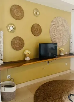 a living room with a tv on a wall at Luka Villas - Luxury 2 Bedroom Private Pool Villa in Seminyak