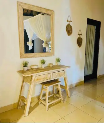 a wooden dressing table with a mirror and a stool at Luka Villas - Luxury 2 Bedroom Private Pool Villa in Seminyak