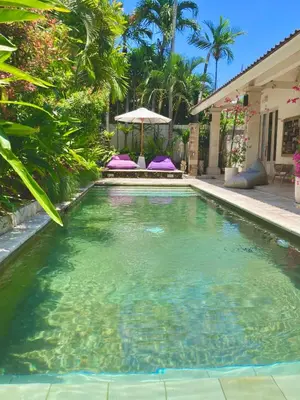 a swimming pool in the middle of a yard at villa LA PLAYA in Seminyak