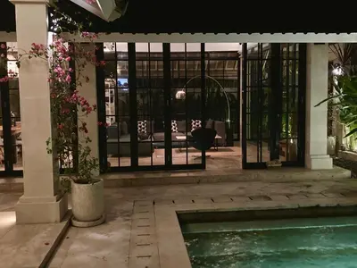 a house with a swimming pool and a patio at villa LA PLAYA in Seminyak