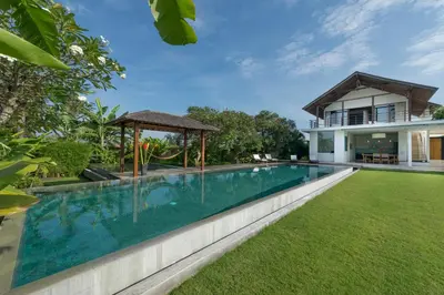 an image of a swimming pool in front of a house at Villa Kavya - 8-minute walk from Berawa Beach in Canggu