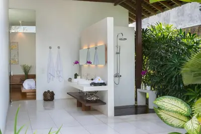 a bathroom with a sink and a shower in it at Villa Kavya - 8-minute walk from Berawa Beach in Canggu
