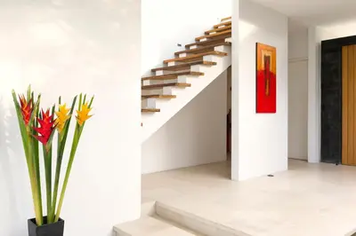 a staircase in a house with a vase with flowers at Villa Kavya - 8-minute walk from Berawa Beach in Canggu
