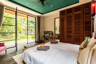 a bedroom with two beds and a large window at PROMO Large Astonishing 5 BR Luxury Private Villa in Canggu