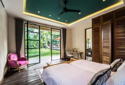 a bedroom with a large bed with a ceiling fan at PROMO Large Astonishing 5 BR Luxury Private Villa in Canggu