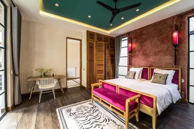 a bedroom with a large bed and a table at PROMO Large Astonishing 5 BR Luxury Private Villa in Canggu