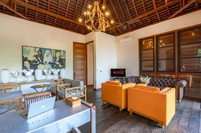 a living room with couches and a table with a laptop at PROMO Large Astonishing 5 BR Luxury Private Villa in Canggu