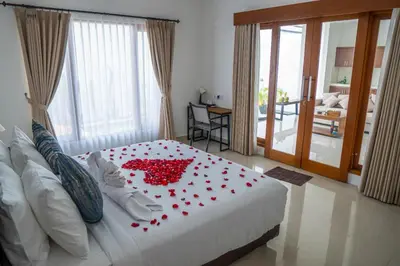 a bedroom with a bed with red roses on it at Villa Akmali Seminyak Basangkasa- 2 Bedrooms in Seminyak