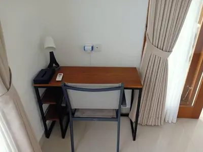 a desk with a chair and a lamp on it at Villa Akmali Seminyak Basangkasa- 2 Bedrooms in Seminyak